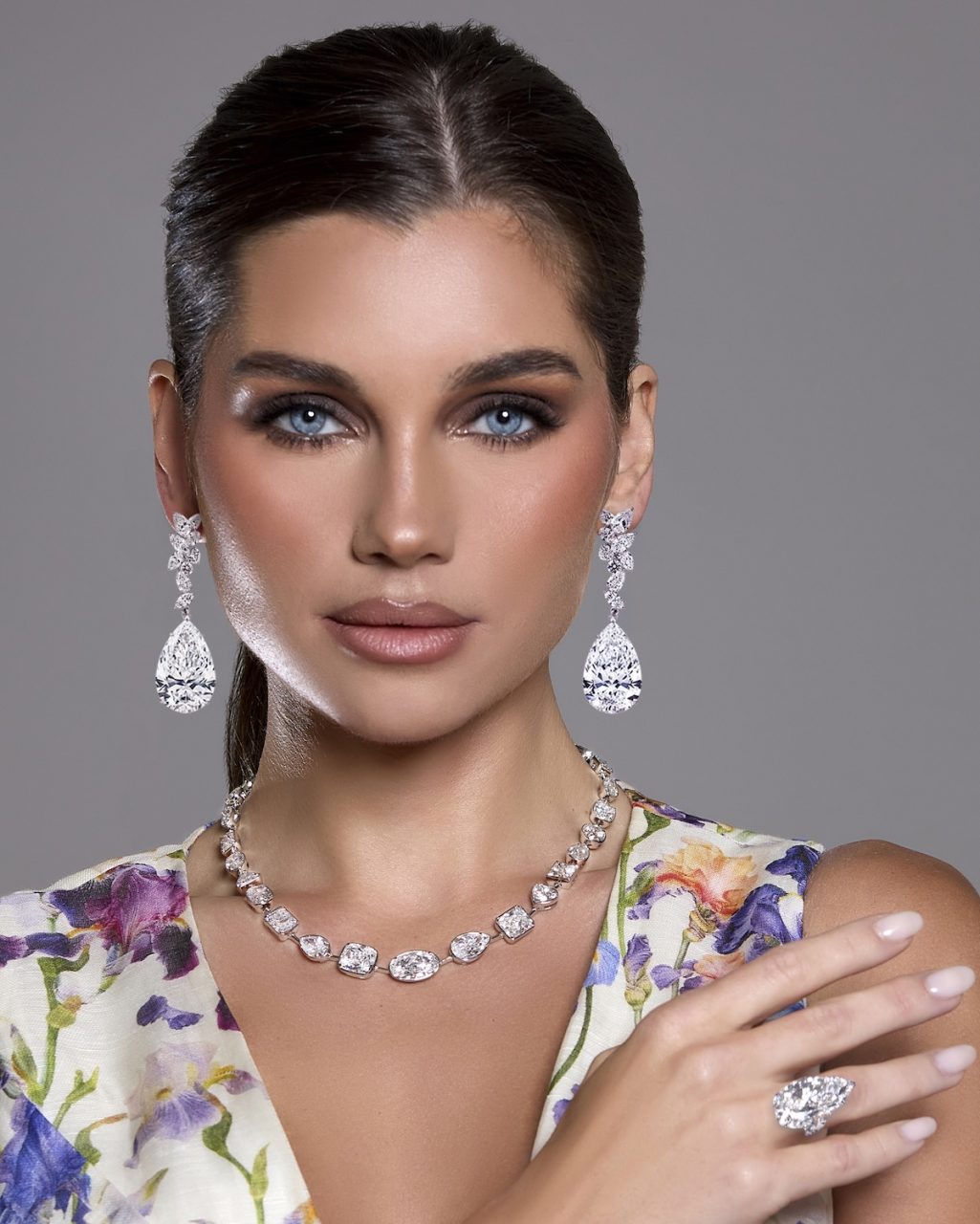 Model wearing The Magnificent Twins — matched pear-shaped diamond chandelier earrings