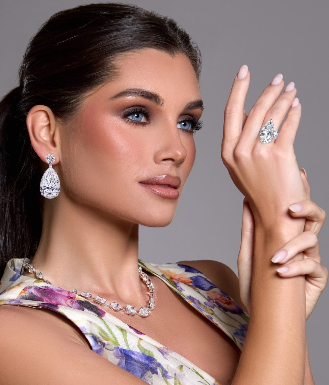 Model wearing The Magnificent Twins — matched pear-shaped diamond drops earrings